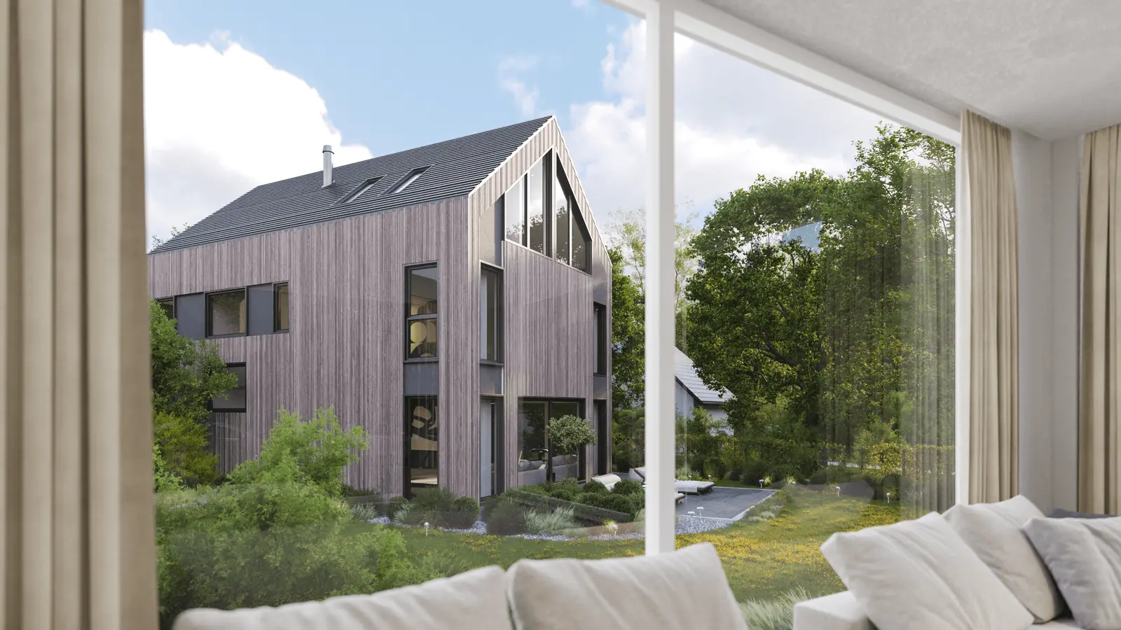 View from a window showing a contemporary wooden house with large windows, surrounded by trees and a garden under a partly cloudy sky.