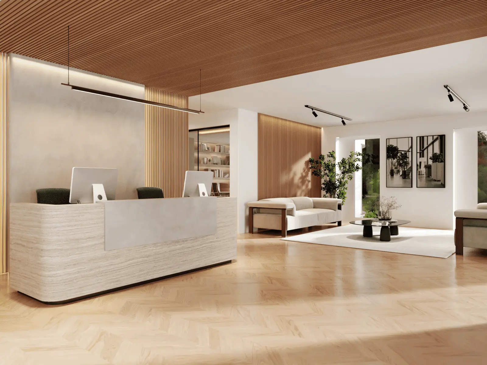 Modern office reception area with two computer desks, seating area with sofas, indoor plants, wooden floors, and wall art.